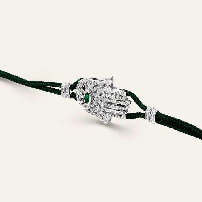 Hamsa Diamond Bracelet Hand crafted in 18k white gold and set with 166 highquality round brilliant cut white diamonds and emerald Bracelets